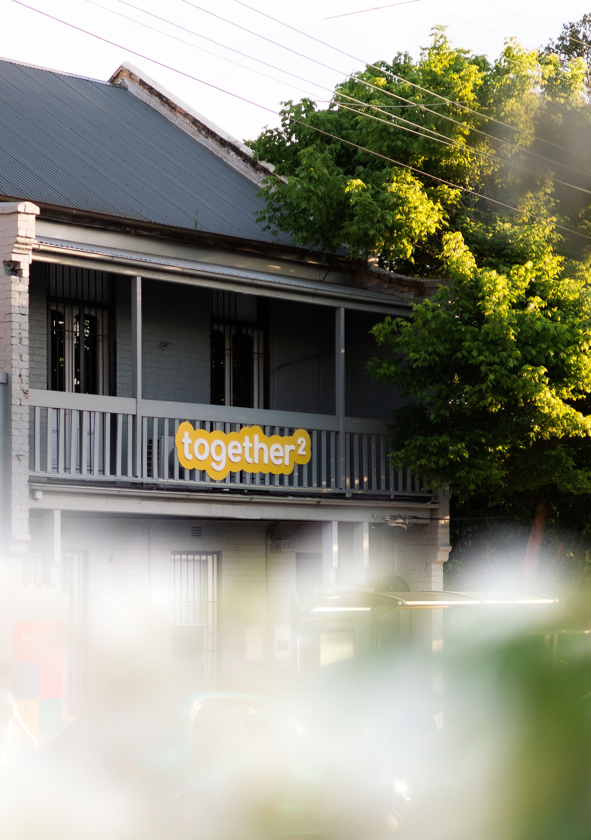 The together² hub on the corner in Rozelle, late afternoon, with the together² sign on the front balcony